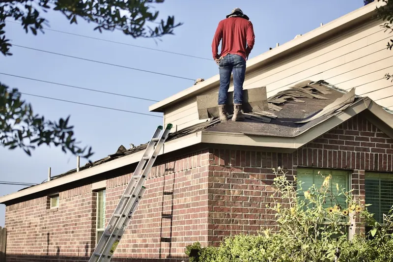 Professional roofer working on a residential roof in Pound Ridge